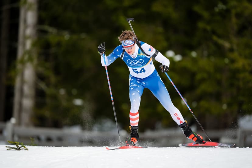 Campbell Wright of the United States skiing in the biathlon sprint, rifle on his back, at the Antholz Olympic venue.