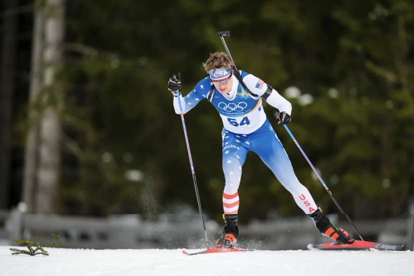 Campbell Wright of the United States skiing in the biathlon sprint, rifle on his back, at the Antholz Olympic venue.